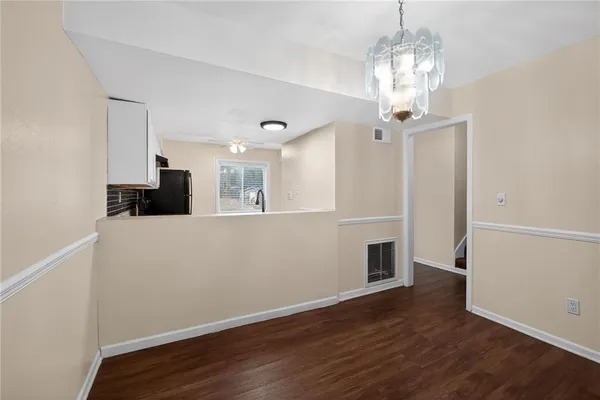 a view of a kitchen with wooden floor and a chandelier