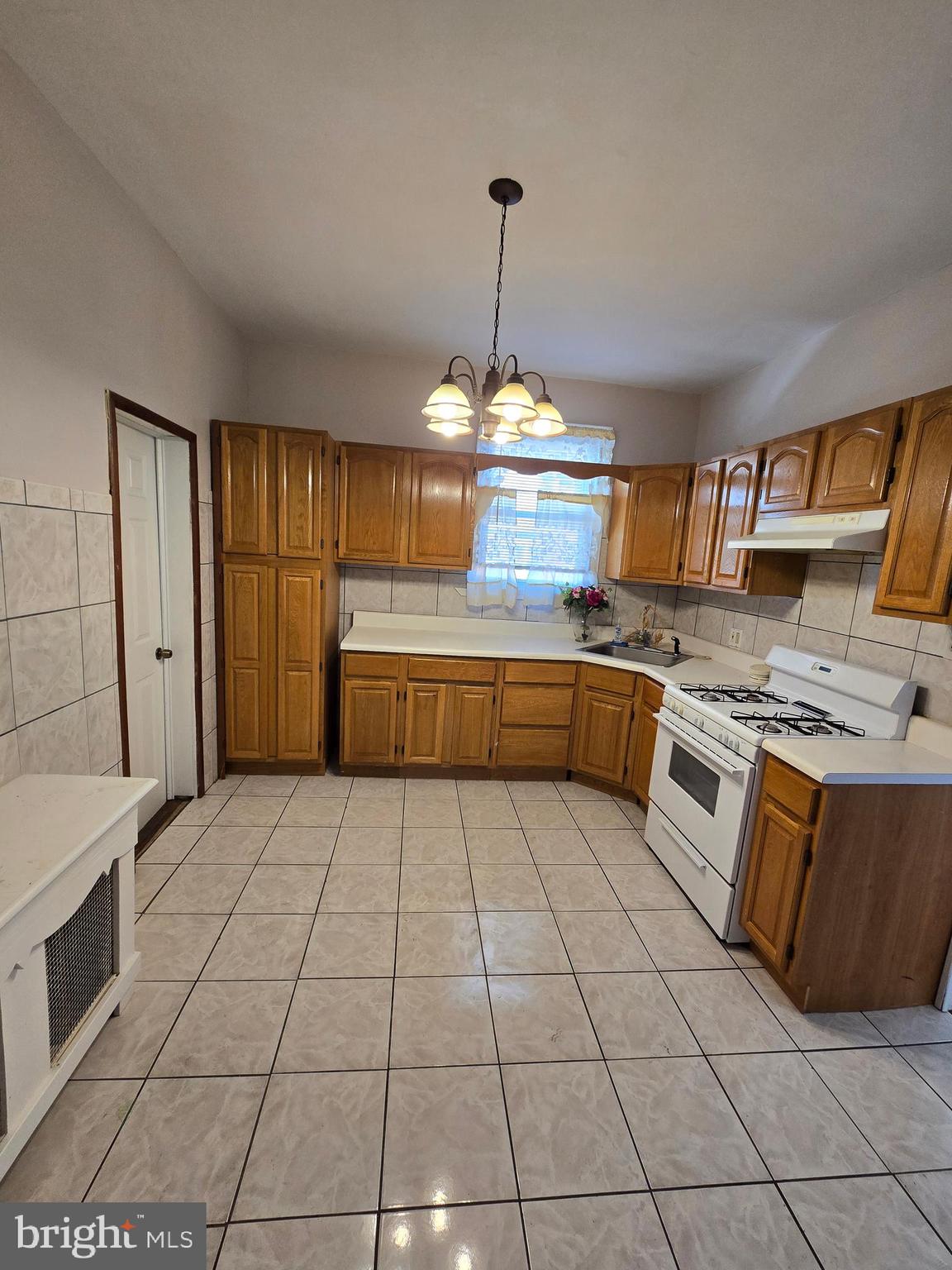 728 South 59th Street Philadelphia, PA 19143 - Photo 12 of 38 a large kitchen with stainless steel appliances granite countertop a stove a sink dishwasher and a refrigerator