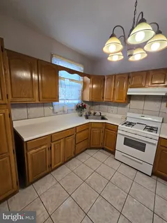 a kitchen with a sink cabinets and window