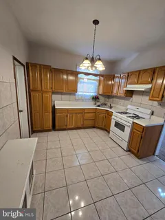 a kitchen with stainless steel appliances granite countertop a sink stove and white cabinets