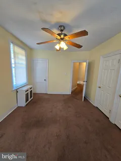 a view of a livingroom with a ceiling fan and window