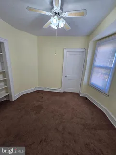 a view of room with window and ceiling fan