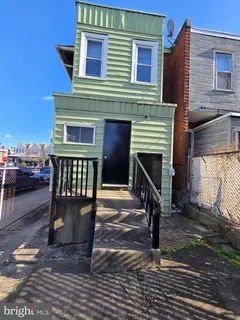 a view of a house with wooden deck and furniture
