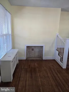 a view of an empty room and wooden floor