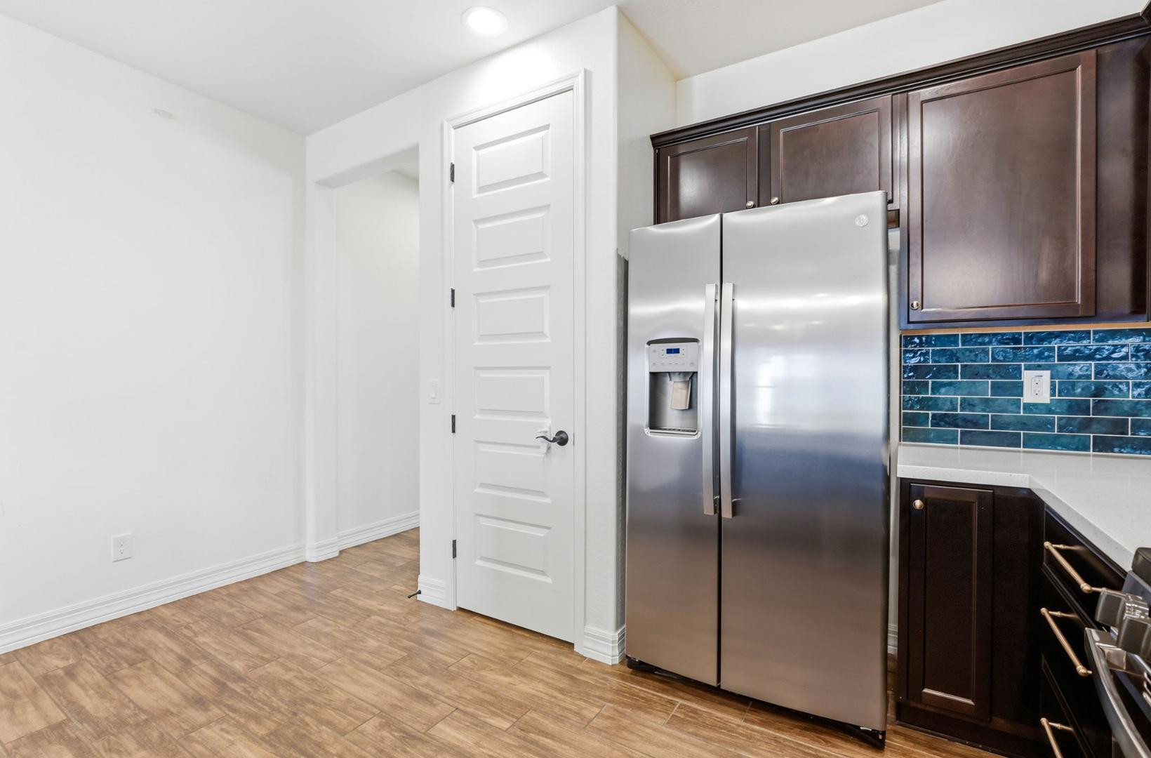 20437 East Estrella Road Queen Creek, AZ 85142 - Photo 24 of 33 a kitchen with a refrigerator and wooden floor