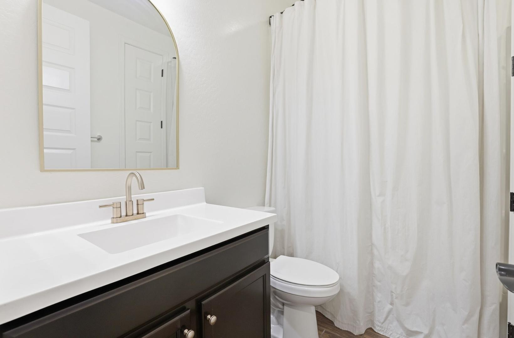 20437 East Estrella Road Queen Creek, AZ 85142 - Photo 30 of 33 a bathroom with a sink a toilet and a mirror