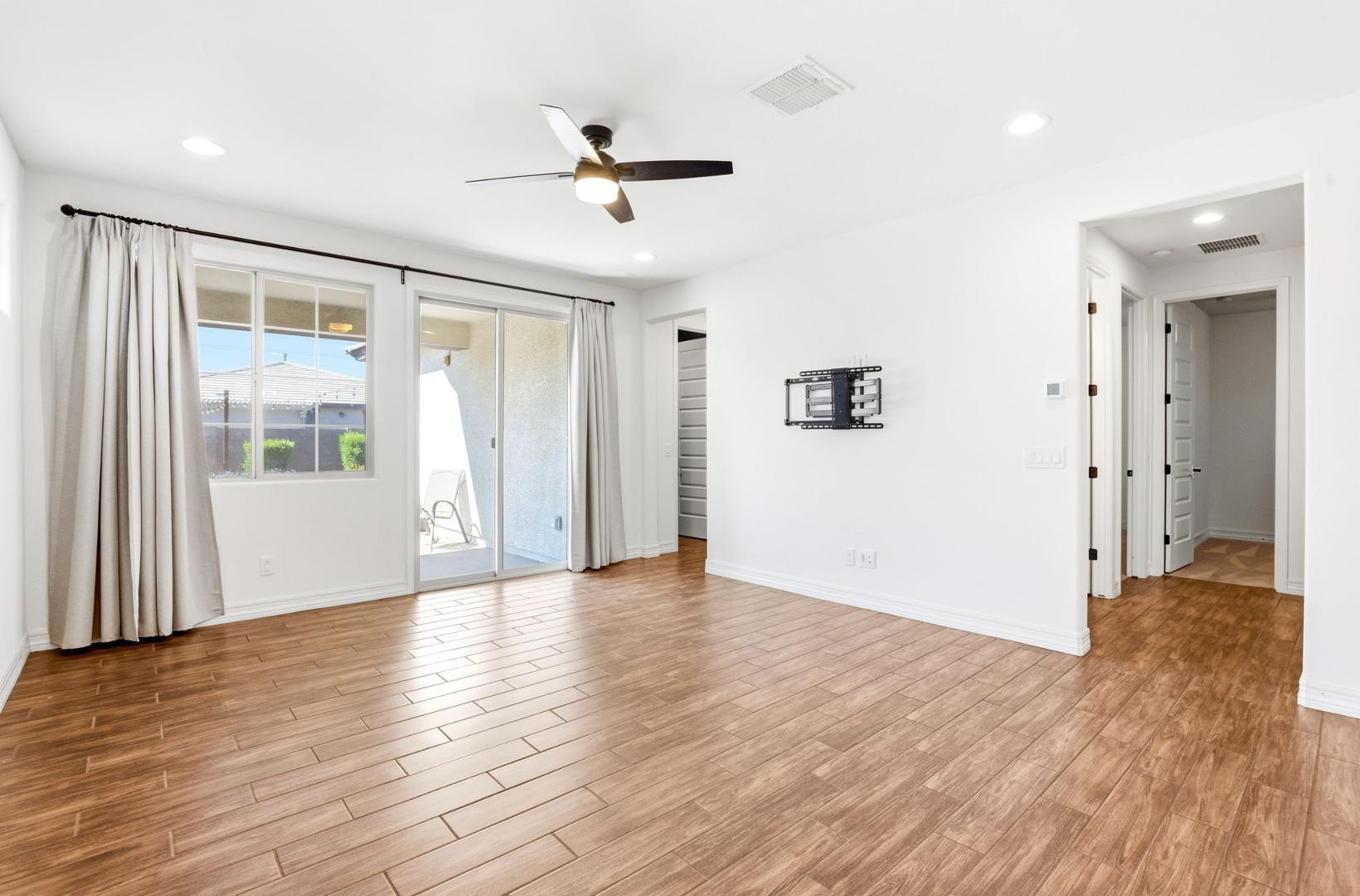20437 East Estrella Road Queen Creek, AZ 85142 - Photo 5 of 33 a view of an empty room with wooden floor and a window
