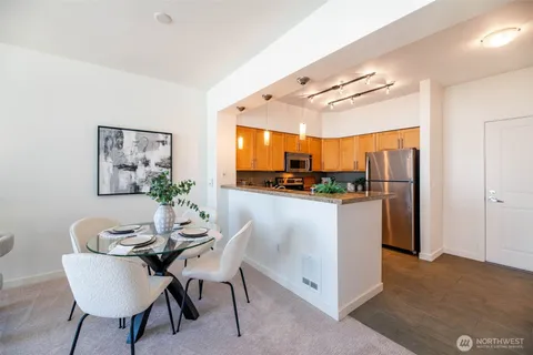 a dining room with furniture and window