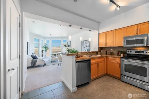 a kitchen with stainless steel appliances granite countertop a stove and a sink