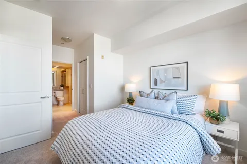 a bedroom with a bed and a painting on the wall