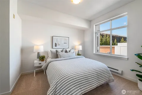 a bedroom with a bed and a window