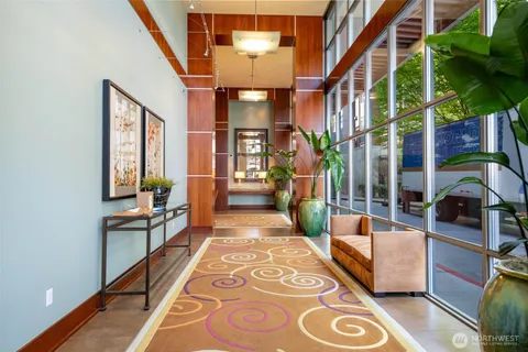 a hallway with a couch and a potted plant