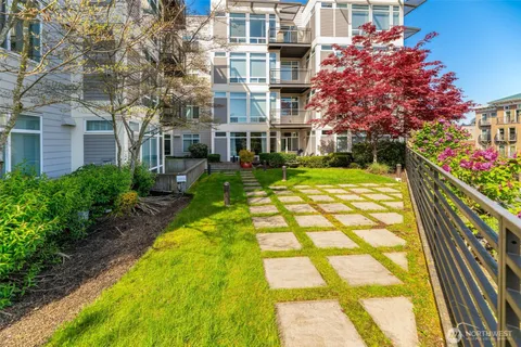 a view of yellow house with a yard