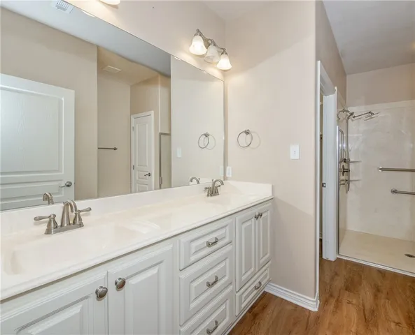 a workspace room with wooden floor a ceiling fan and windows