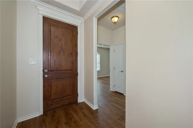 a large kitchen with stainless steel appliances granite countertop a large counter top a sink and a wooden floor