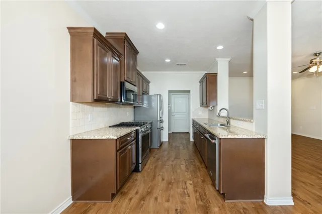 a view of a livingroom with a kitchen counter tops and a stove