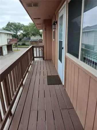 a view of balcony with wooden floor and fence