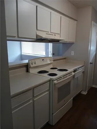 a kitchen with stainless steel appliances granite countertop a sink and a refrigerator