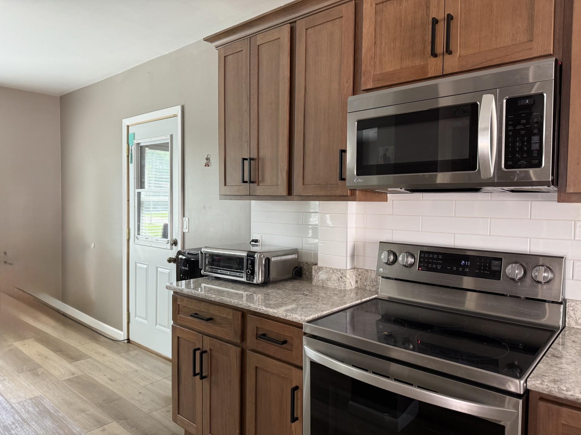 2731 7th Street Peru, IL 61354 - Photo 14 of 25 a kitchen with granite countertop a stove and a microwave