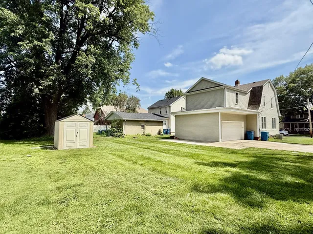 a front view of a house with a garden and yard