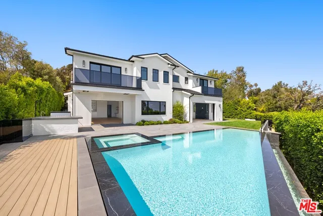 a house with swimming pool in front of it
