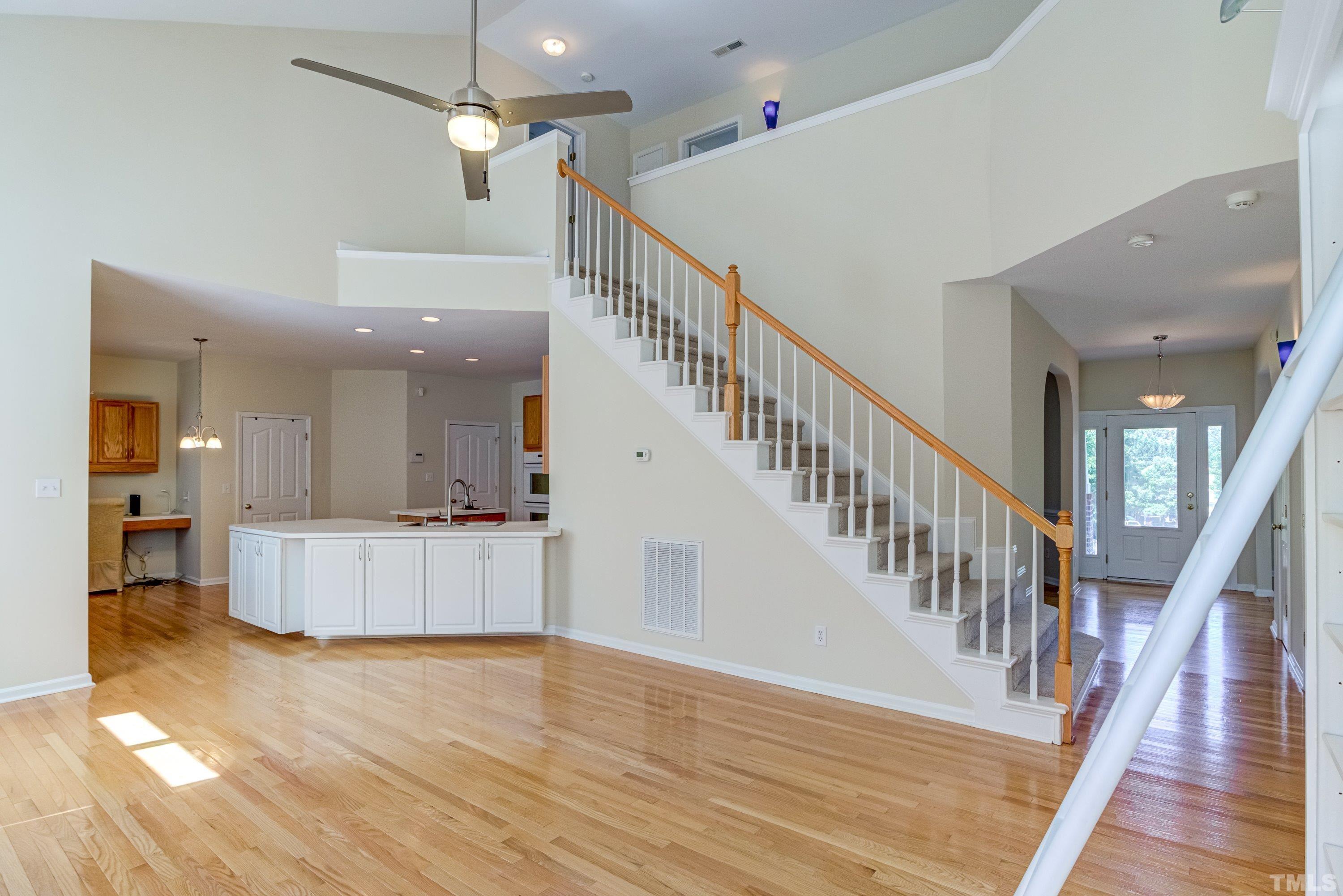 8613 Benzinger Drive Raleigh, NC 27613 - Photo 12 of 48 a view of an entryway and kitchen with wooden floor