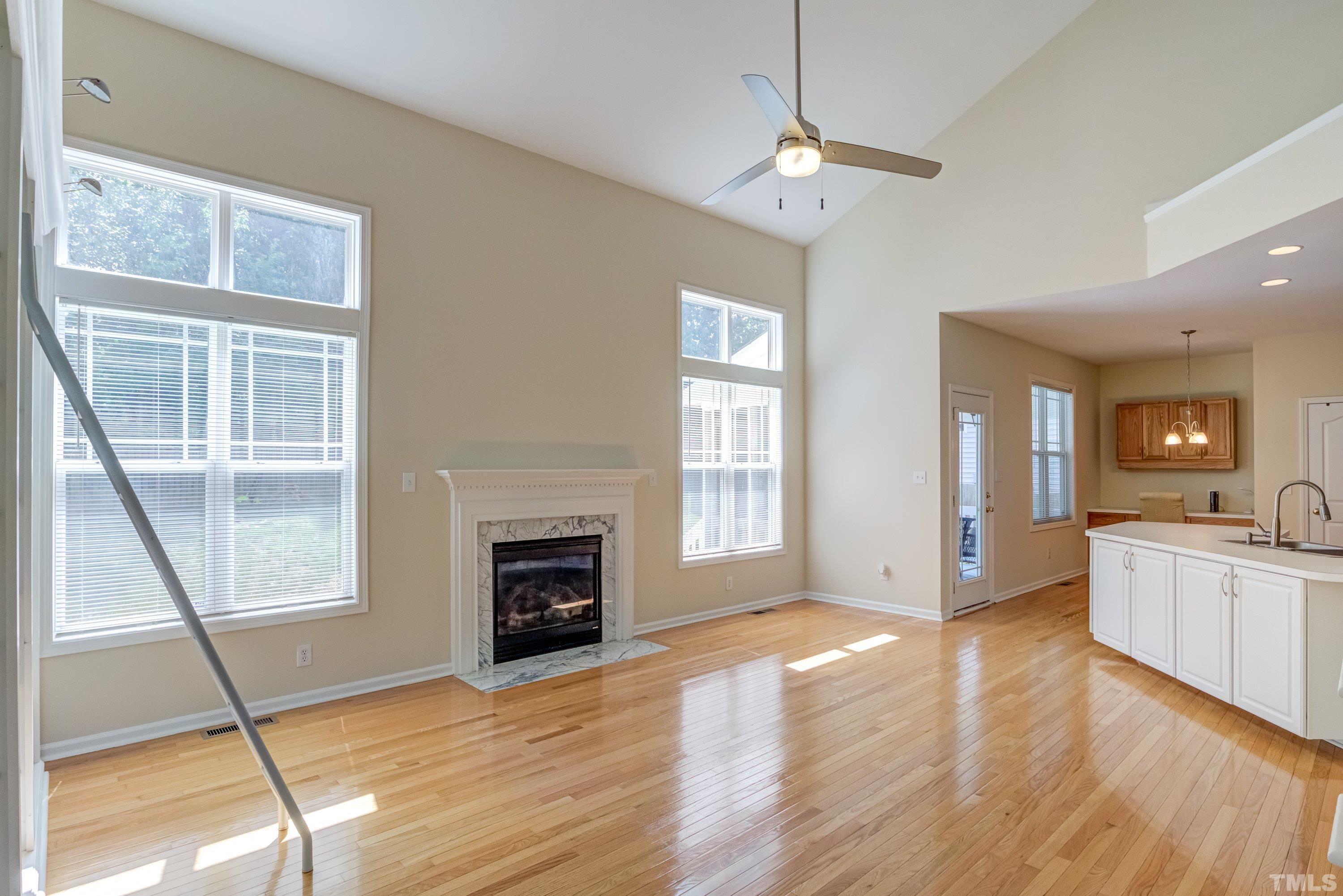 8613 Benzinger Drive Raleigh, NC 27613 - Photo 13 of 48 a view of an empty room with window and wooden floor