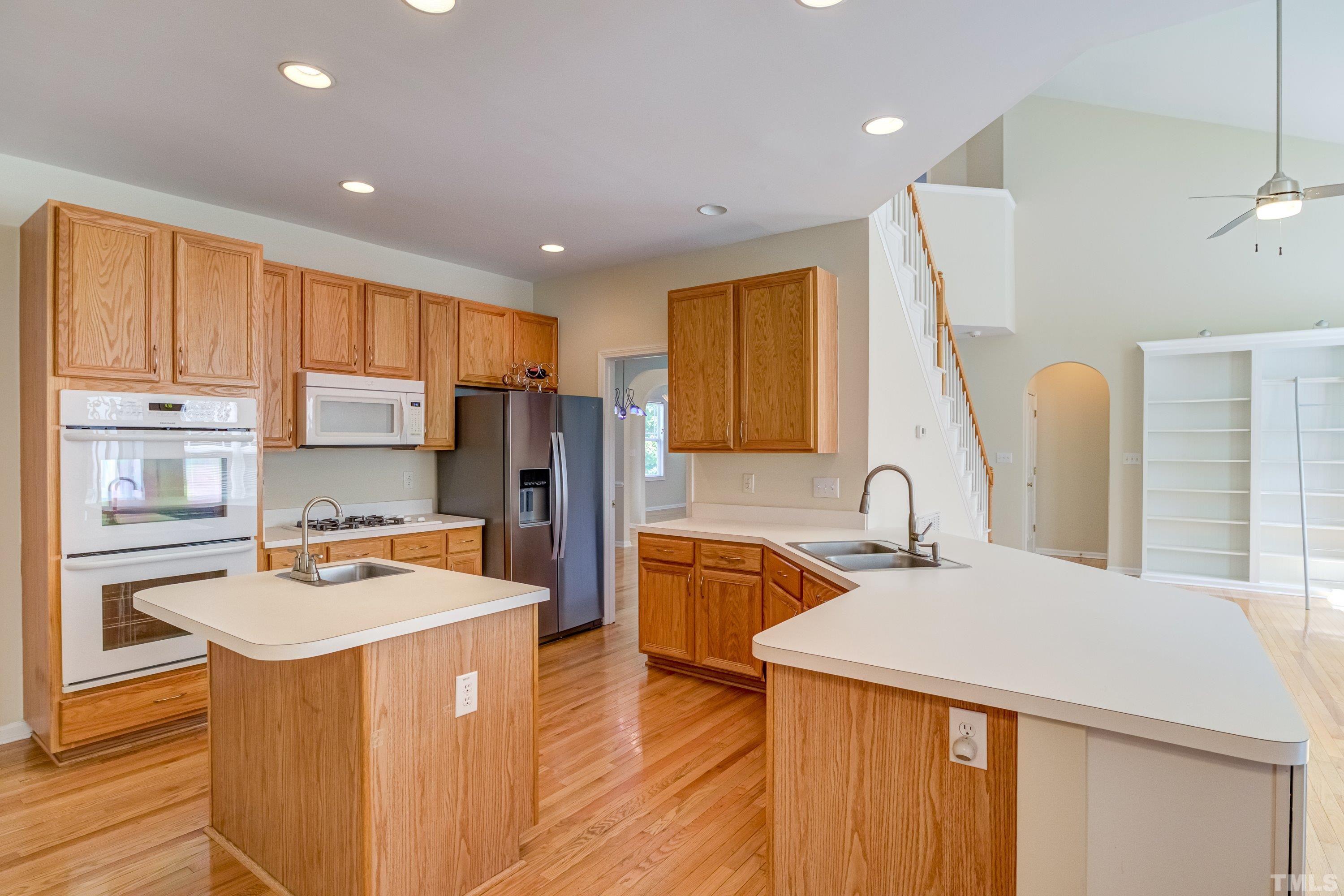 8613 Benzinger Drive Raleigh, NC 27613 - Photo 15 of 48 a kitchen with stainless steel appliances granite countertop a sink stove and refrigerator
