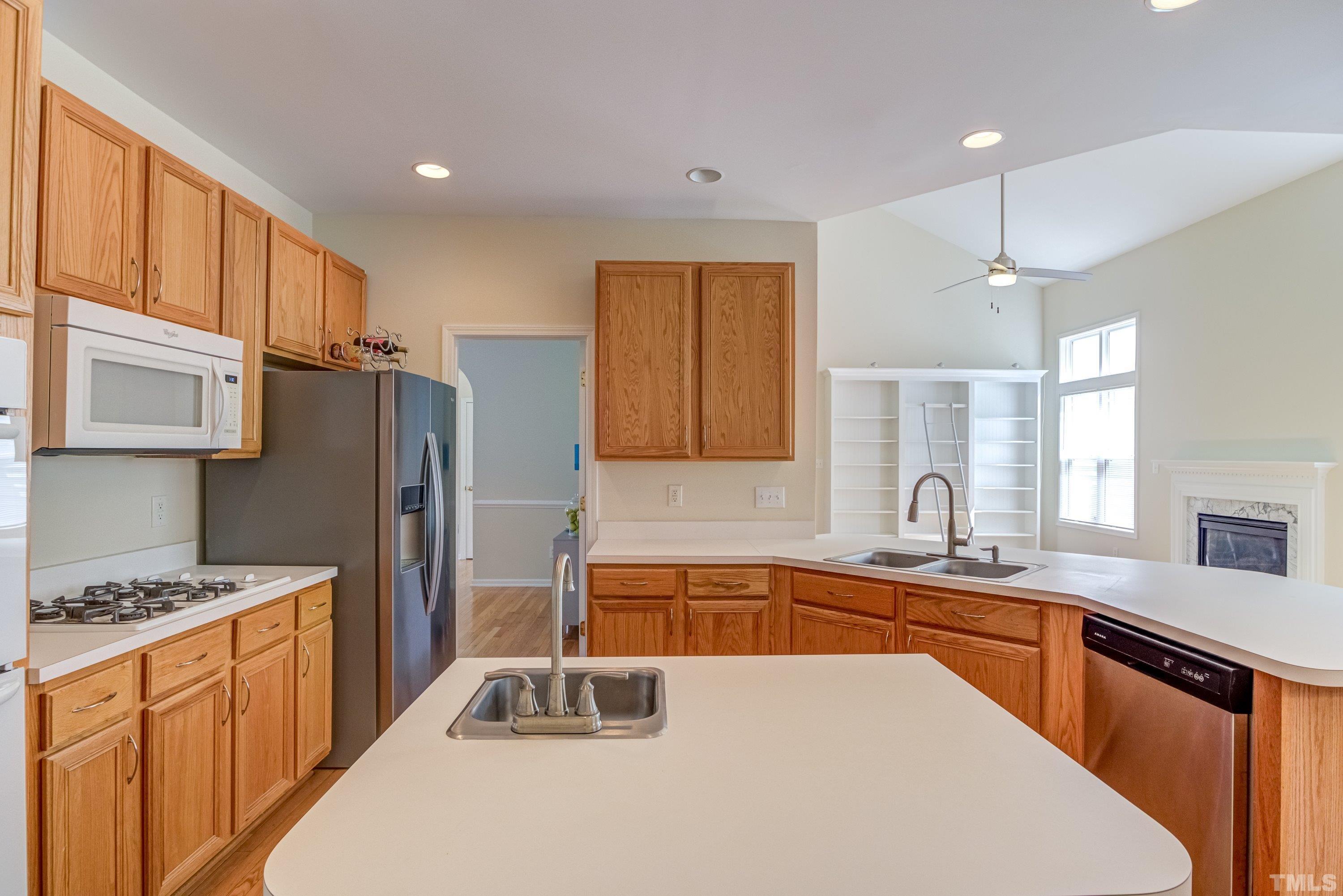 8613 Benzinger Drive Raleigh, NC 27613 - Photo 16 of 48 a kitchen with stainless steel appliances granite countertop a sink stove and refrigerator