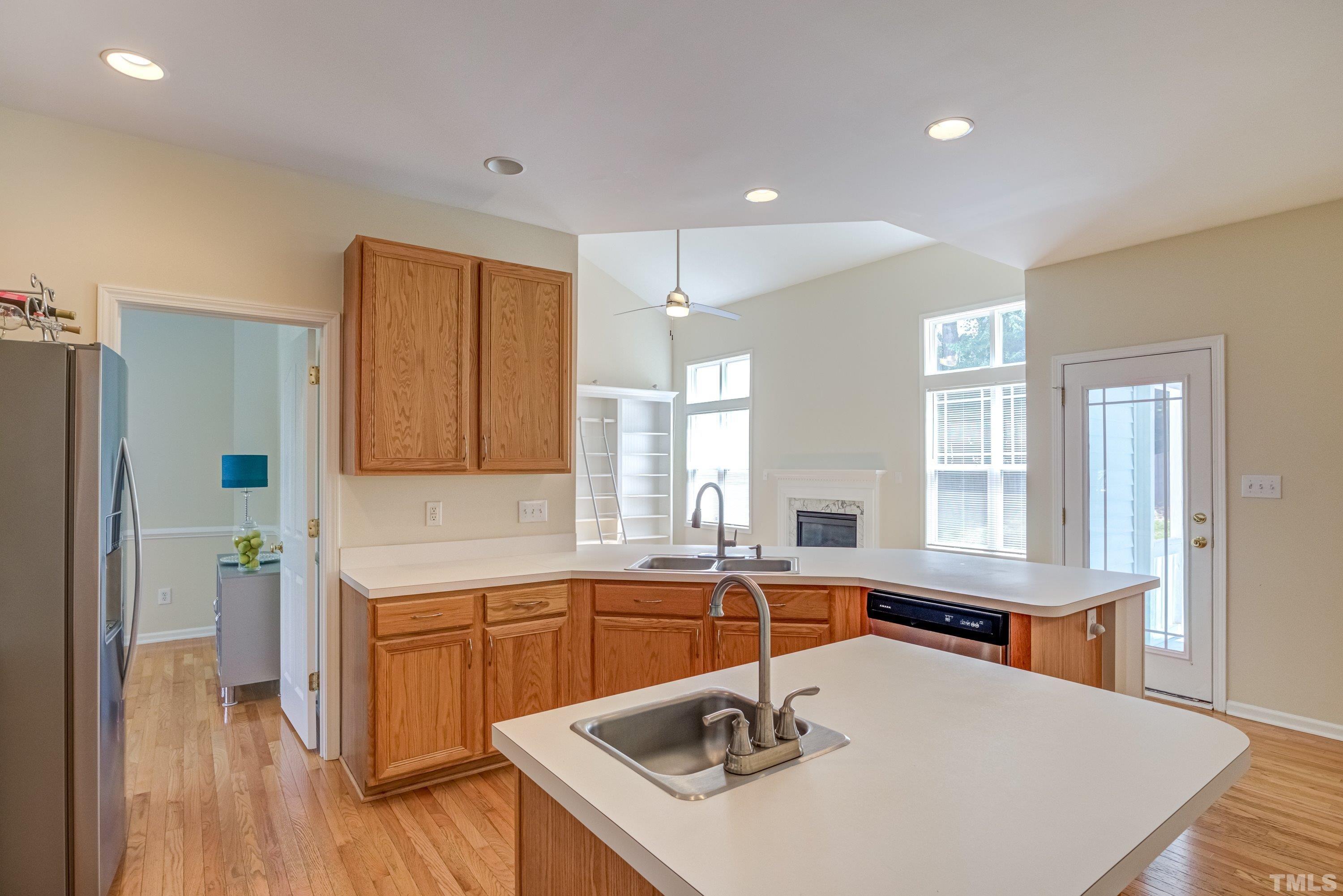 8613 Benzinger Drive Raleigh, NC 27613 - Photo 17 of 48 a kitchen with a sink a counter top space and stainless steel appliances
