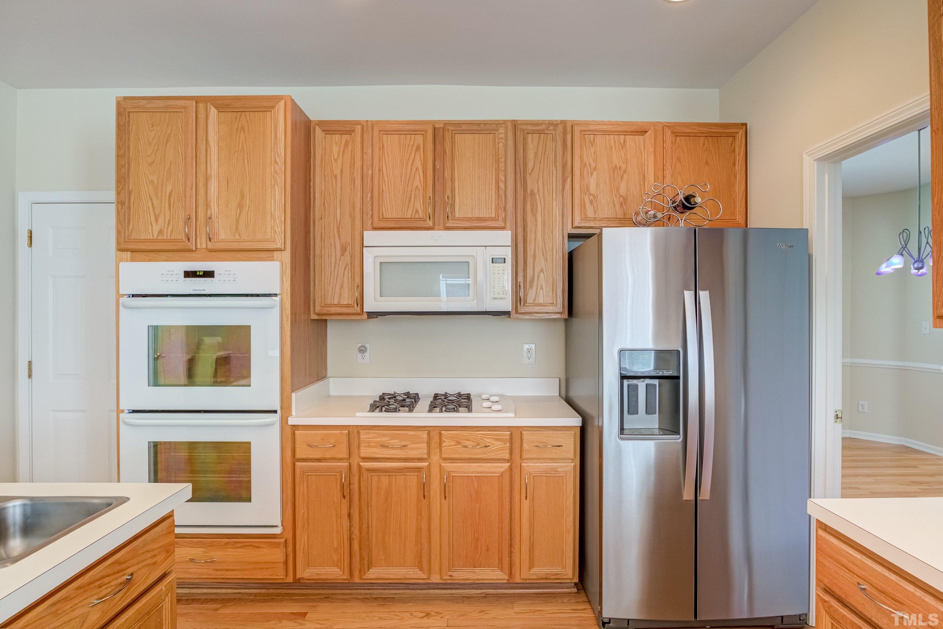 8613 Benzinger Drive Raleigh, NC 27613 - Photo 19 of 48 a kitchen with stainless steel appliances granite countertop a refrigerator and a stove top oven