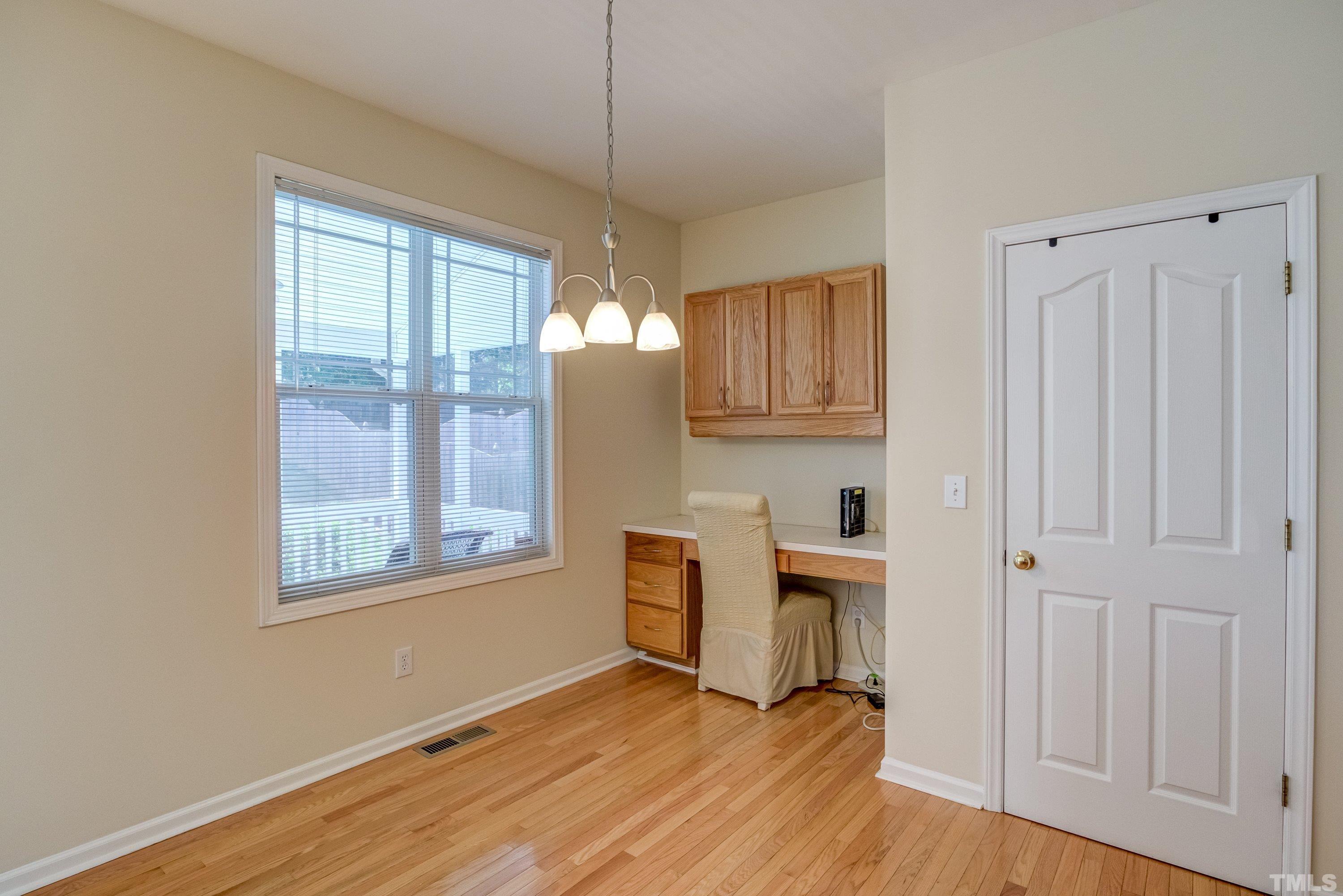 8613 Benzinger Drive Raleigh, NC 27613 - Photo 20 of 48 a view of a kitchen with wooden floor and a window