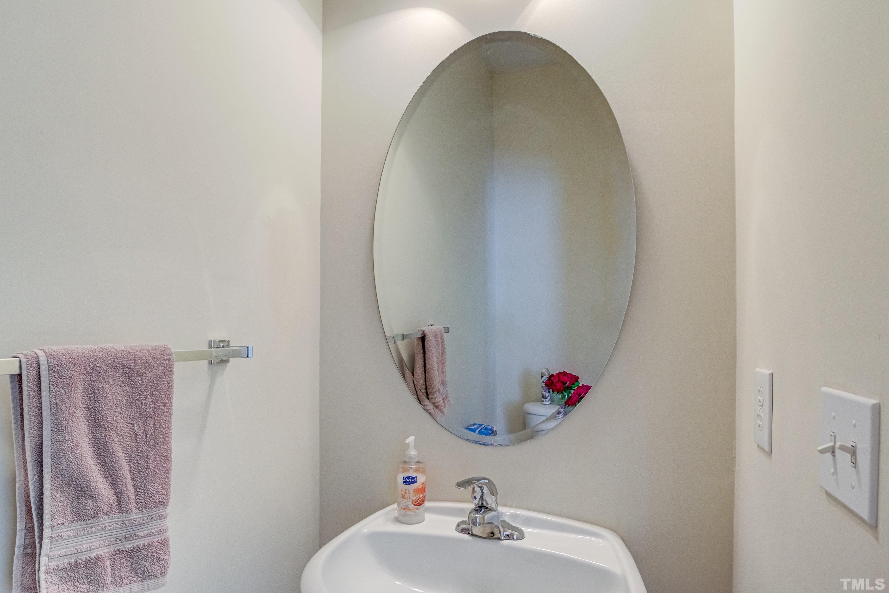 8613 Benzinger Drive Raleigh, NC 27613 - Photo 21 of 48 a bathroom with a sink and a mirror