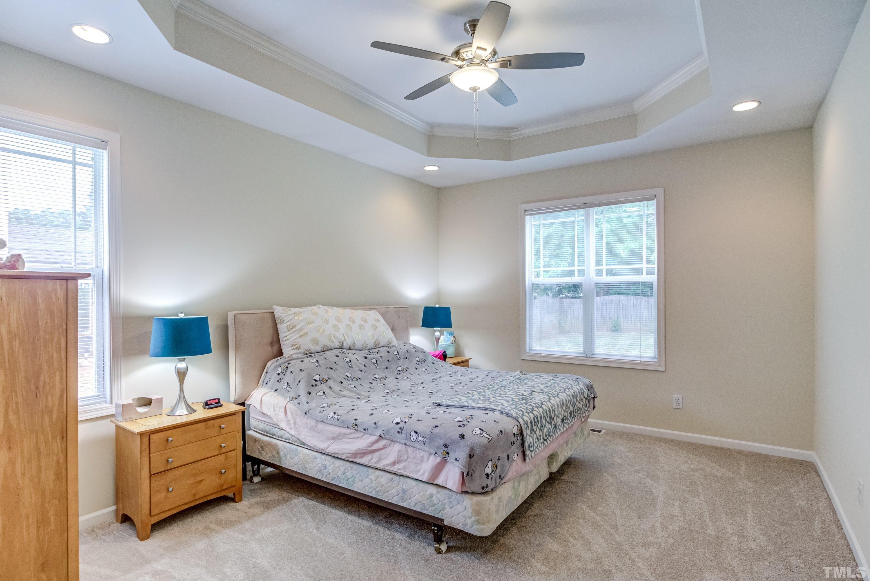 8613 Benzinger Drive Raleigh, NC 27613 - Photo 22 of 48 a bedroom with a bed chandelier and a window