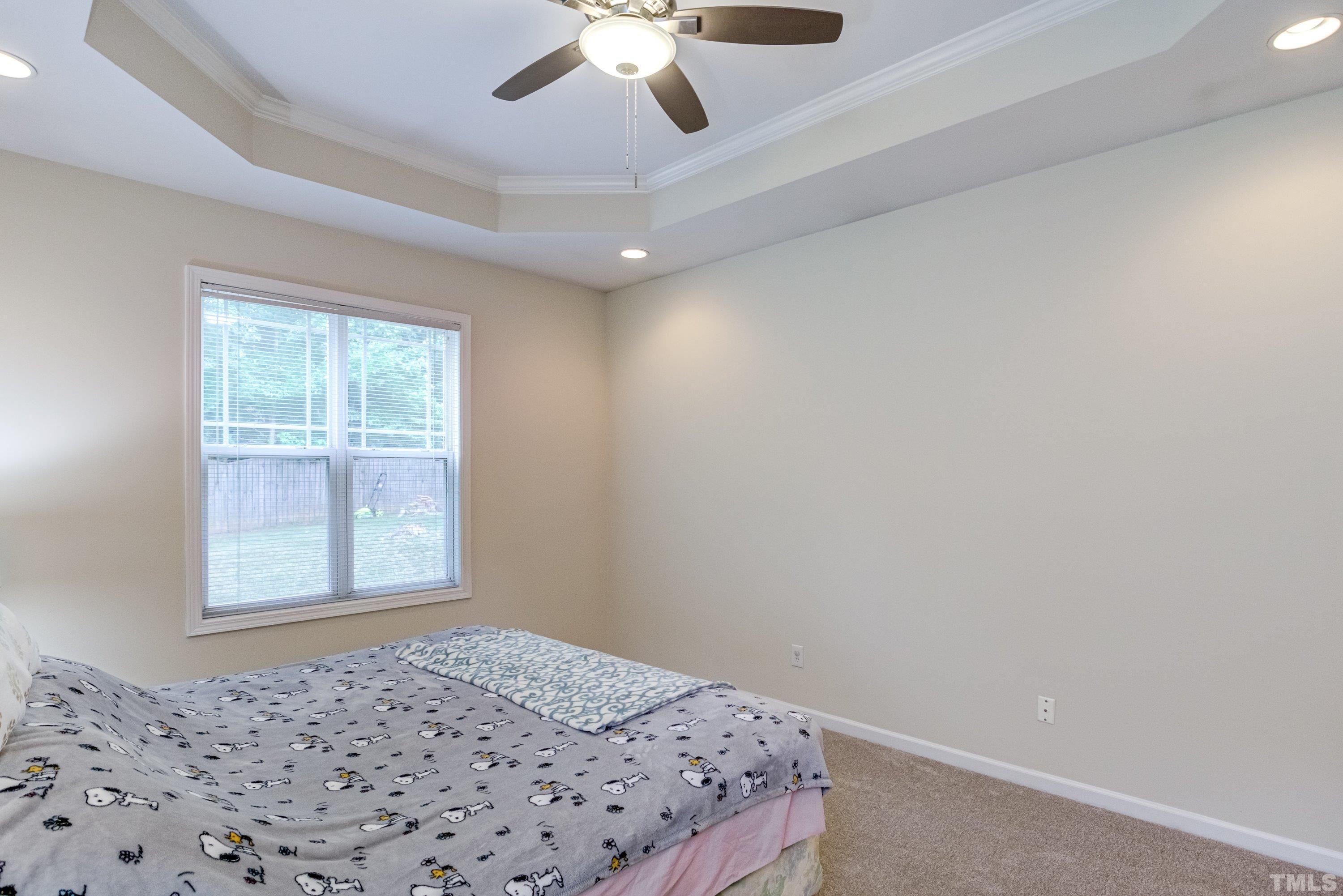 8613 Benzinger Drive Raleigh, NC 27613 - Photo 24 of 48 a bedroom with a bed and a window