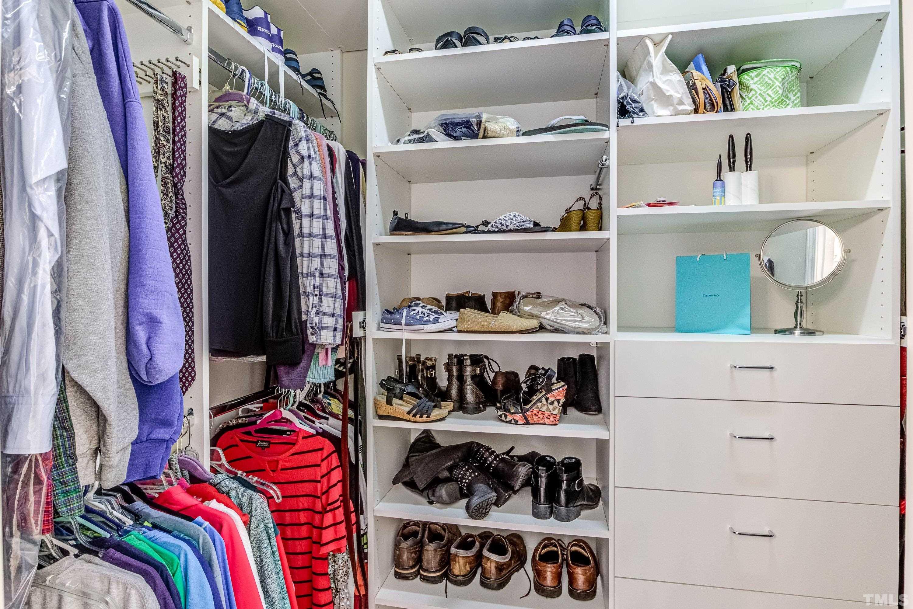 8613 Benzinger Drive Raleigh, NC 27613 - Photo 27 of 48 a view of walk in closet with clothes and shoes
