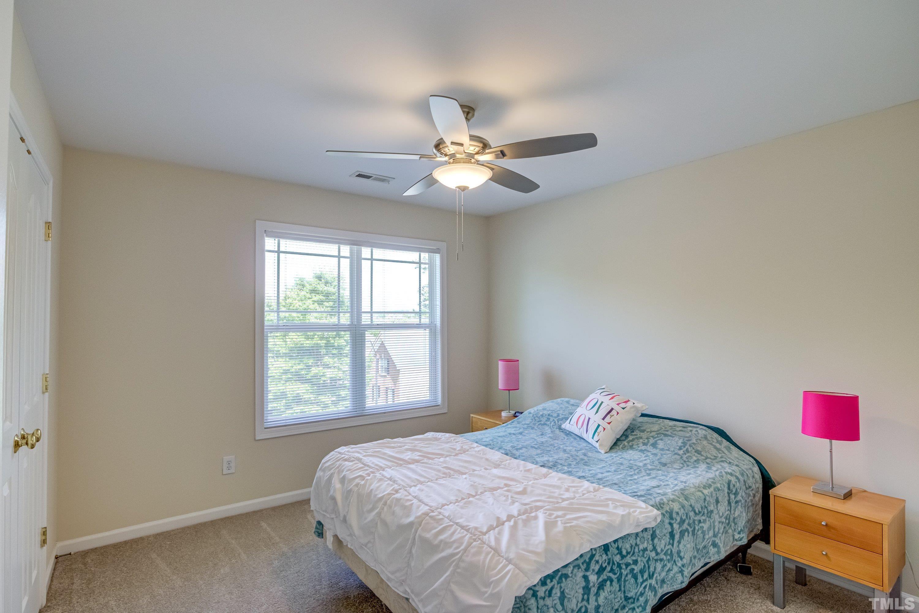 8613 Benzinger Drive Raleigh, NC 27613 - Photo 28 of 48 a bedroom with a bed and a chandelier