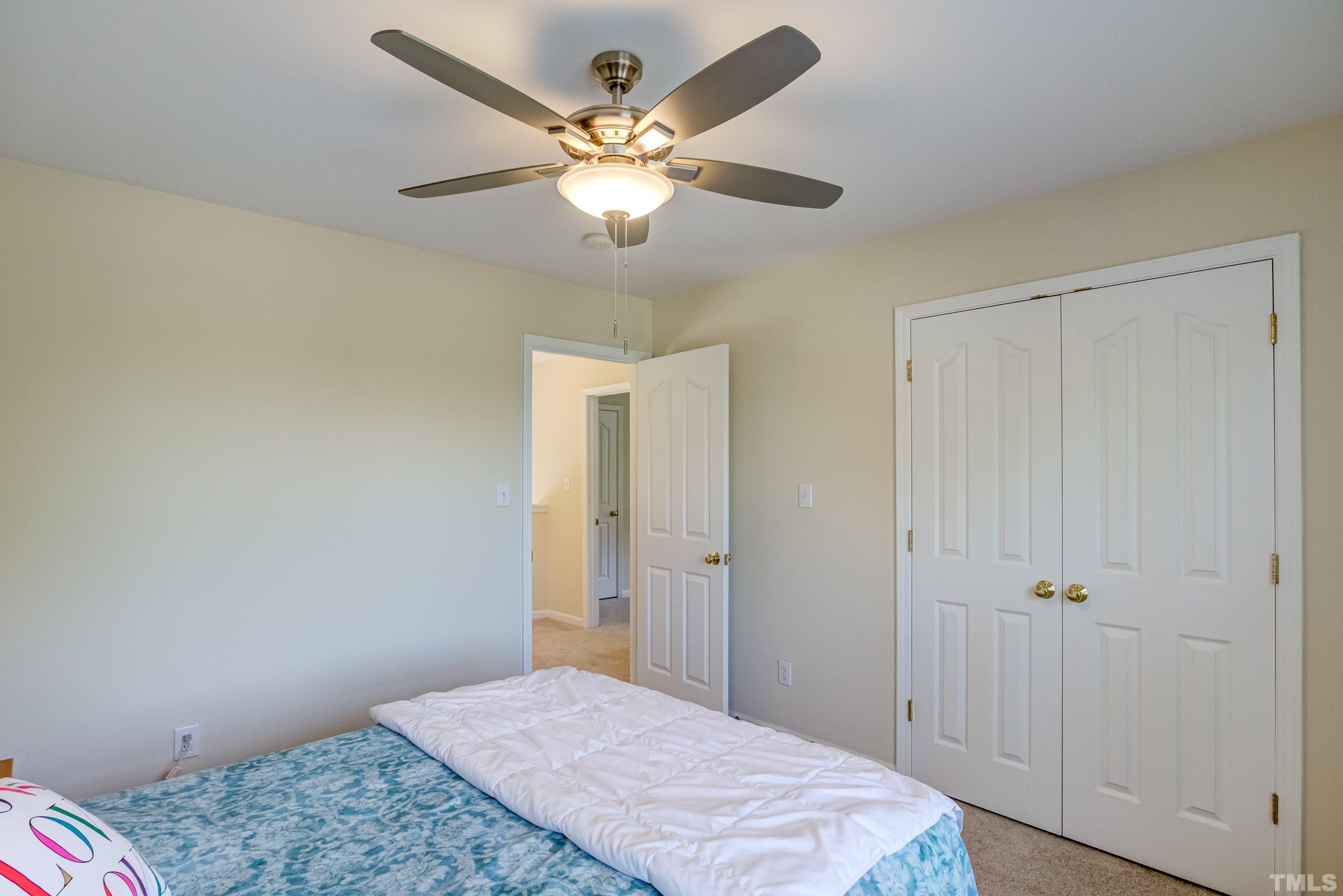 8613 Benzinger Drive Raleigh, NC 27613 - Photo 29 of 48 a bedroom with a bed and a chandelier
