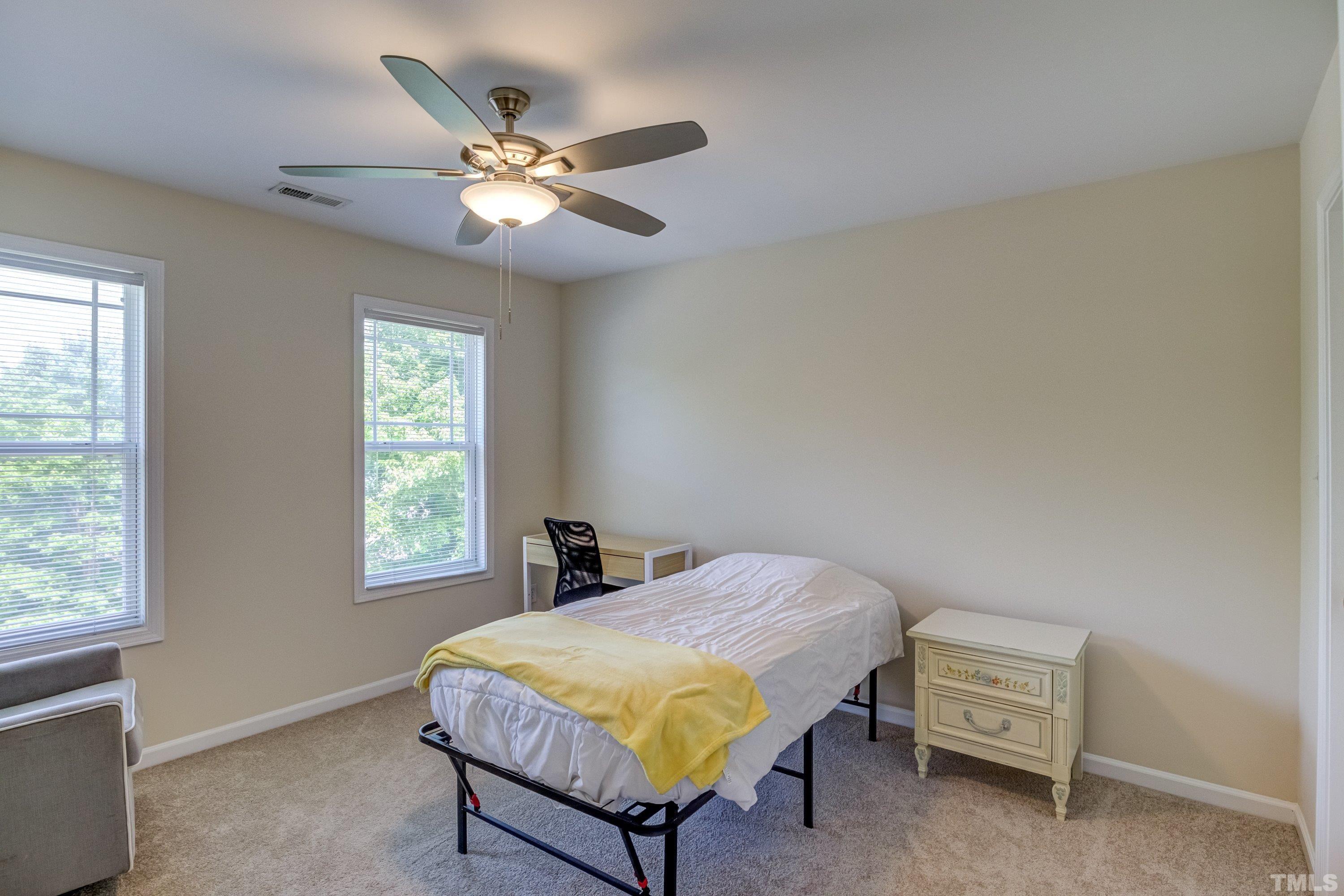 8613 Benzinger Drive Raleigh, NC 27613 - Photo 30 of 48 a bedroom with a bed and a window