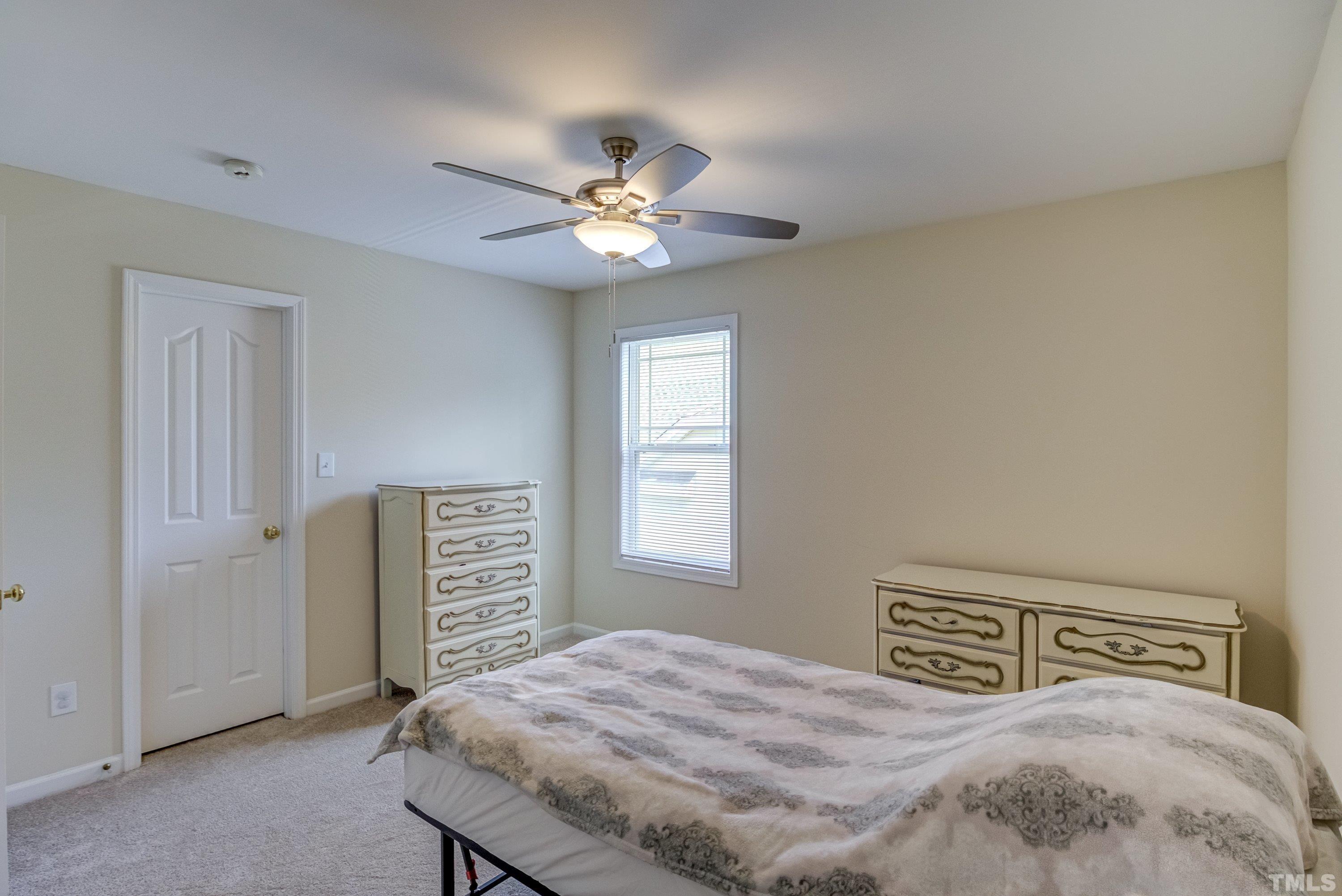 8613 Benzinger Drive Raleigh, NC 27613 - Photo 33 of 48 a bedroom with a bed and a window