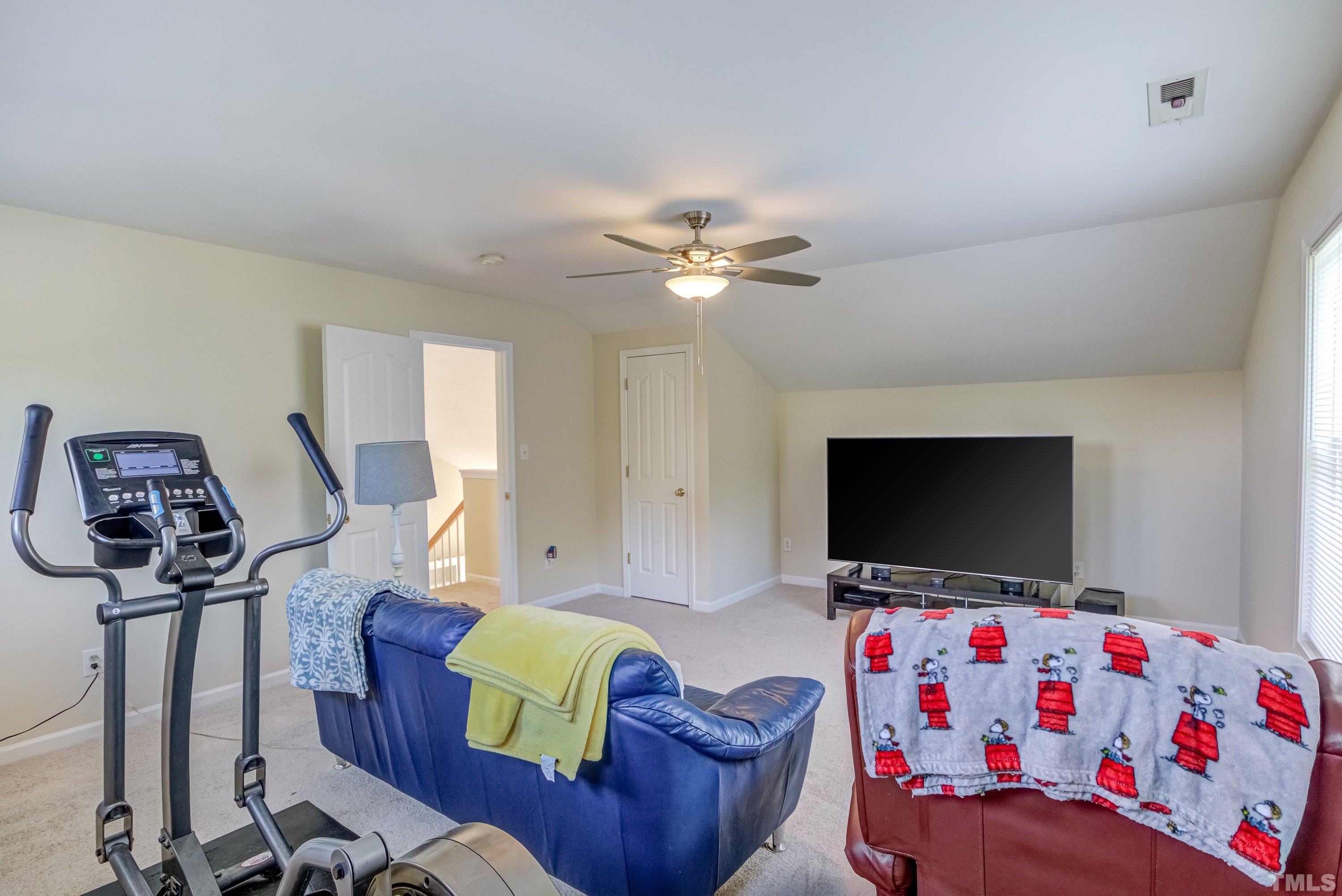 8613 Benzinger Drive Raleigh, NC 27613 - Photo 36 of 48 a living room with furniture and a flat screen tv