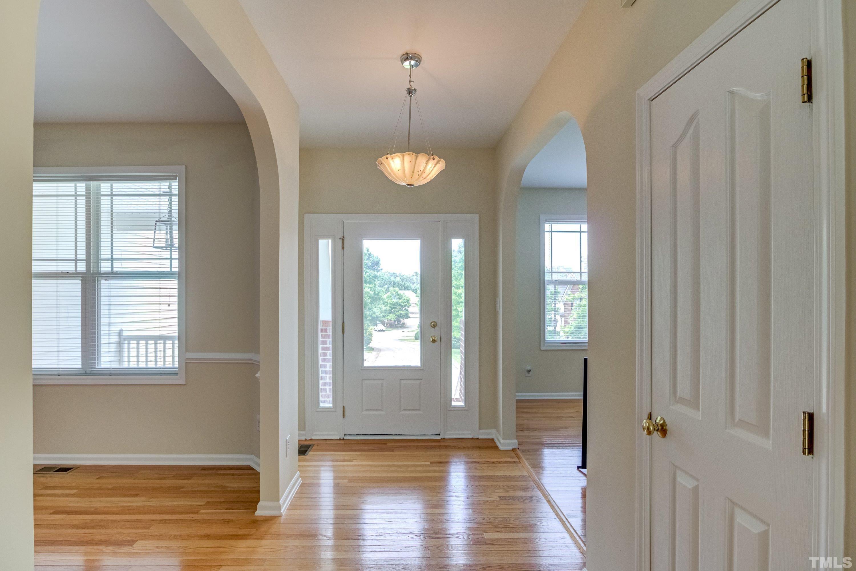 8613 Benzinger Drive Raleigh, NC 27613 - Photo 4 of 48 a view of a room with wooden floor and windows