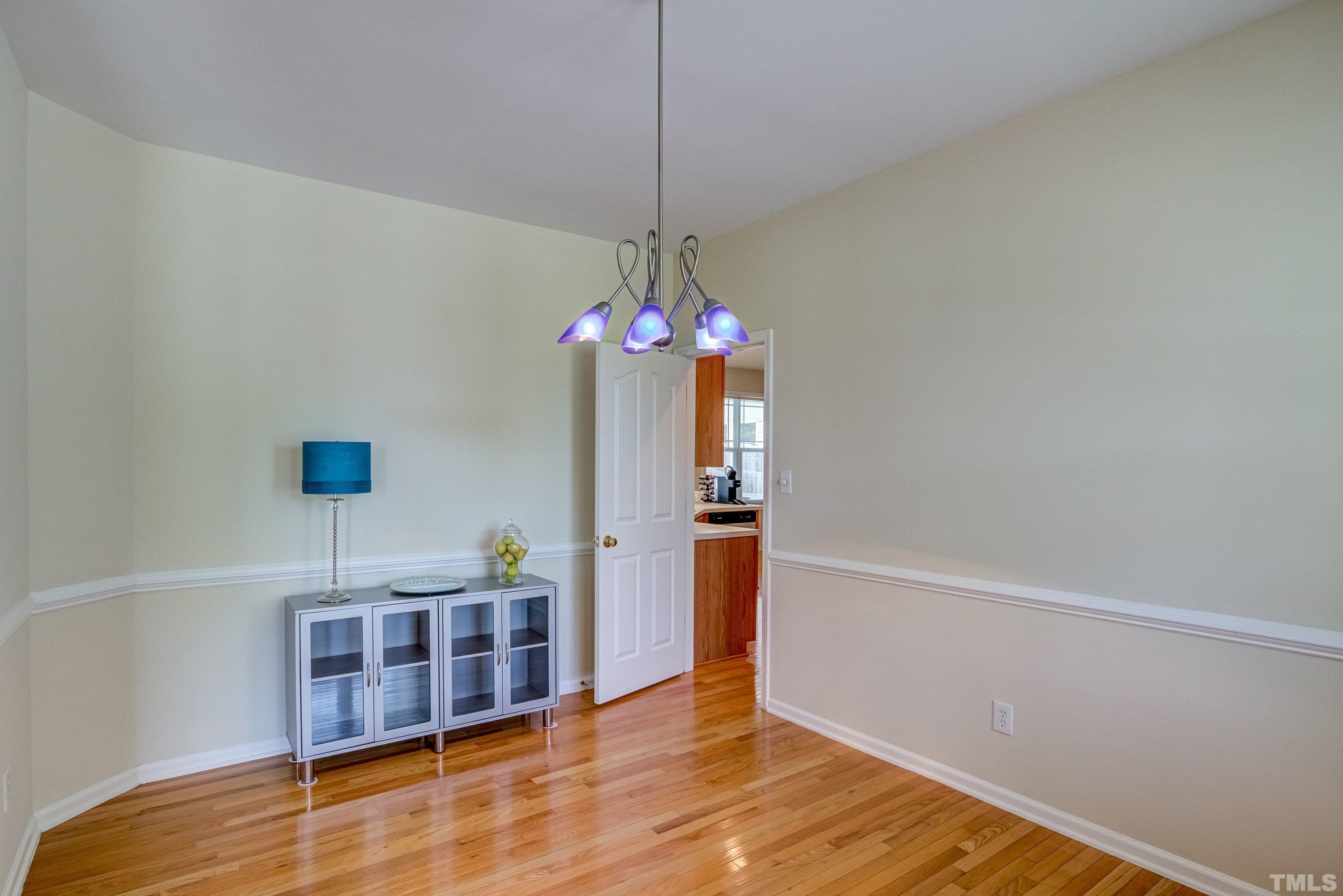 8613 Benzinger Drive Raleigh, NC 27613 - Photo 8 of 48 a room with furniture and a chandelier