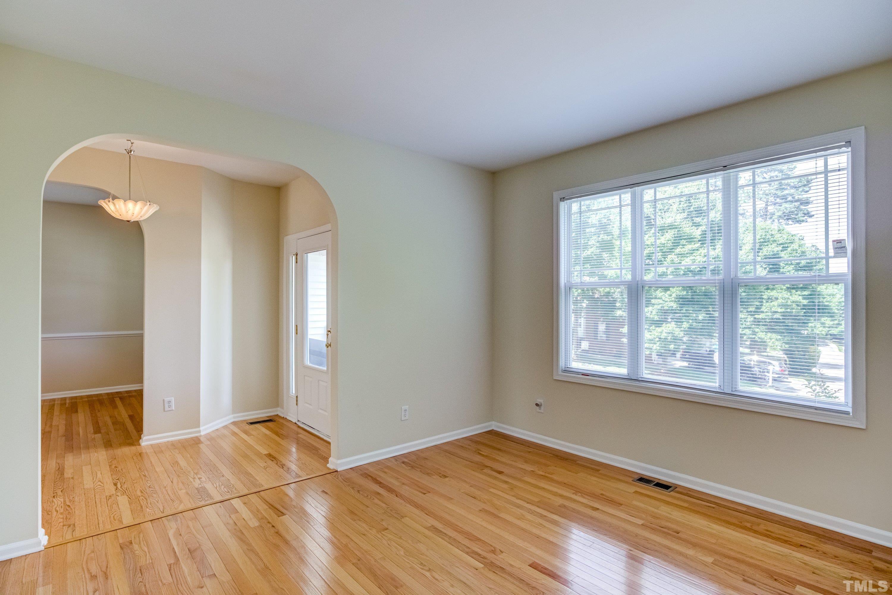 8613 Benzinger Drive Raleigh, NC 27613 - Photo 9 of 48 a view of empty room with wooden floor and fan