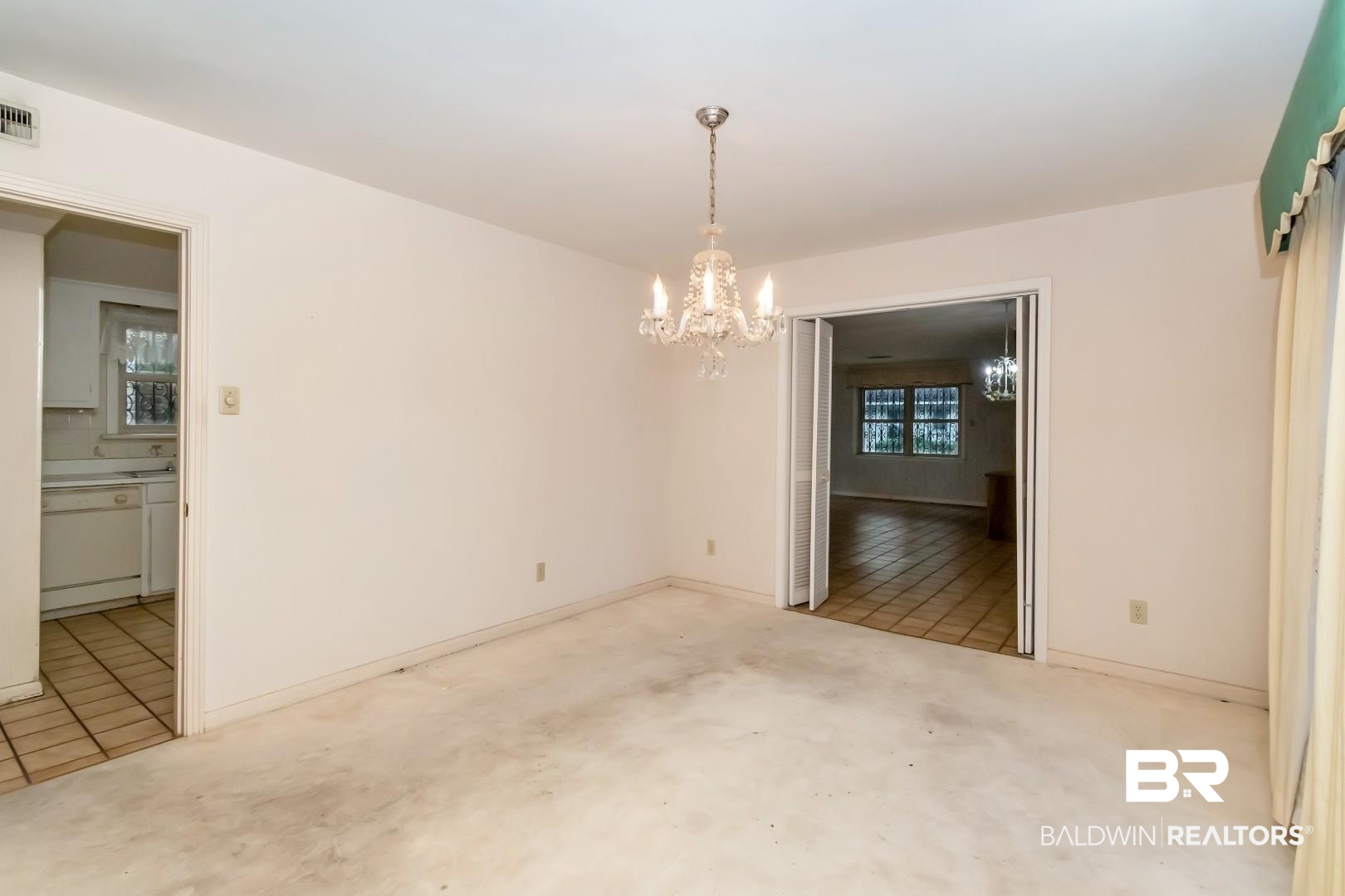 3715 South Conway Drive Mobile, AL 36608 - Photo 9 of 24 Spare room featuring baseboards, visible vents, carpet floors, and an inviting chandelier