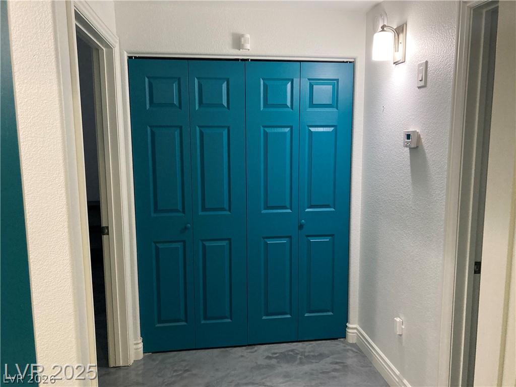 9050 West Warm Springs Road, Unit 1027 Las Vegas, NV 89148 - Photo 14 of 44 Functional hallway with bright teal closet doors offers convenient storage.