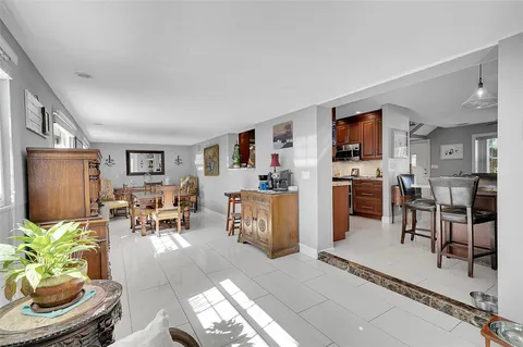 a living room with furniture and a dining room with kitchen view