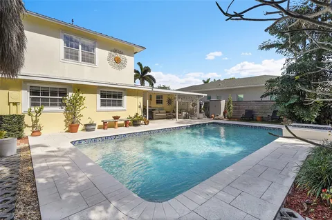 a view of a patio with swimming pool table and chairs