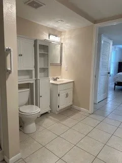 a bathroom with a toilet shower and sink