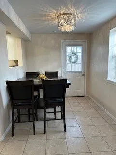 a view of a dining room with furniture and window